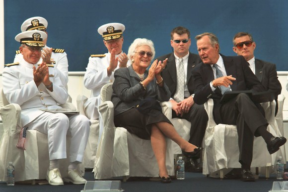 030906-N-2383B-039 Newport News, Va. (Aug. 26, 2003) -- President George H.W. Bush and former First Lady Barbara Bush share applause with Adm. Vern Clark, Chief of Naval Operations (CNO), as they watch the Navy's parachute team "The Leapfrogs" perform during a keel laying ceremony honoring the building of the nuclear-powered aircraft carrier George H.W. Bush (CVN 77). This will be the 10th and final Nimitz-class aircraft carrier as it undergoes the first of four ceremonial traditions that will happen throughout the life of the warship. U.S. Navy photo by Chief Photographer's Mate Johnny Bivera. (RELEASED).